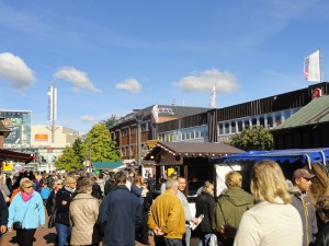 Besucher gehen über die Flaniermeile an den Ständen entlang.