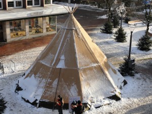 Das Foto zeigt das geschlossene, leicht verschneite Tipi-Zelt am Tag.